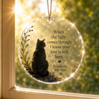 Personalized cat memorial window hanging ornament catching sunlight by a window