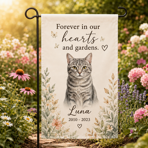 Personalized cat memorial garden flag displayed in a sunny flower garden