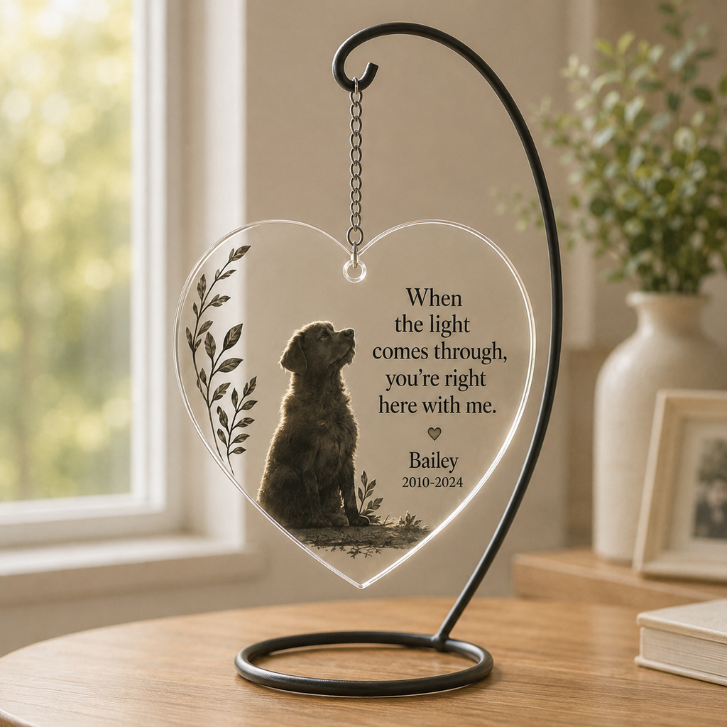 Pet memorial hanging ornament displayed on a stand near a window